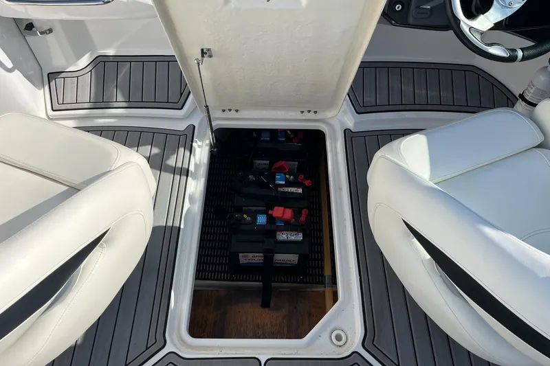 Slide: The Image of 2015 Monterey M4 boat interior with open battery compartment between seats. - 33