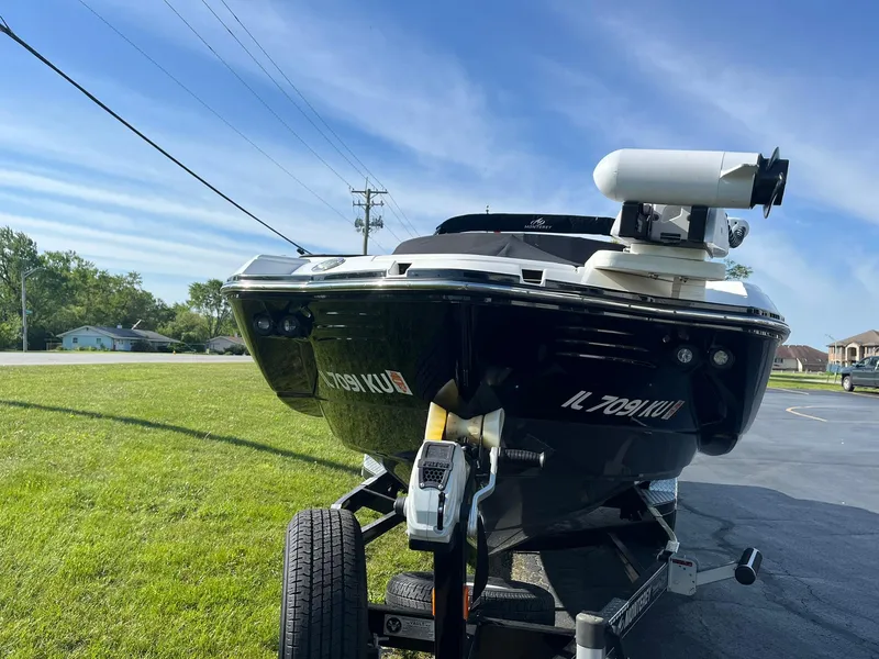Slide: The Image of Monterey M4 boat on trailer, parked on grass, under clear blue sky. - 4