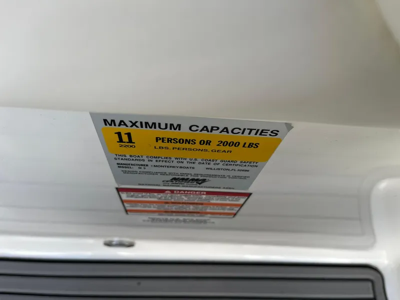 Slide: The Image of Maximum capacity label on 2015 Monterey M4 boat, indicating 11 persons or 2000 lbs. - 41