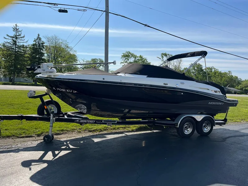 Slide: The Image of 2015 Monterey M4 boat on trailer, parked outdoors on a sunny day. - 5