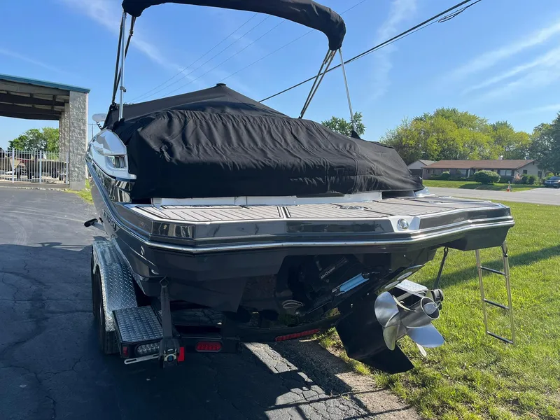 Slide: The Image of 2015 Monterey M4 boat on trailer, covered, with outboard motor, parked on grass. - 7