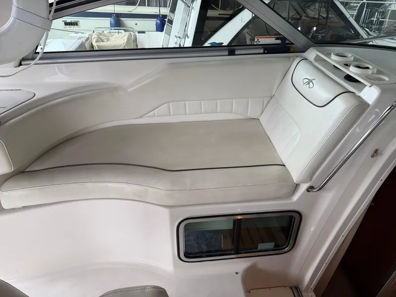 Slide: The Image of 2003 Monterey 302 Cruiser interior seating with white upholstery and cup holders. - 10