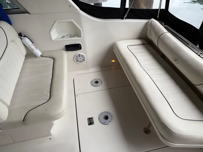 Slide: The Image of 2003 Monterey 302 Cruiser interior with white seating and storage compartments. - 12