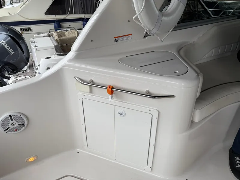 Slide: The Image of 2003 Monterey 302 Cruiser interior with seating and storage, featuring Yamaha engine in background. - 13