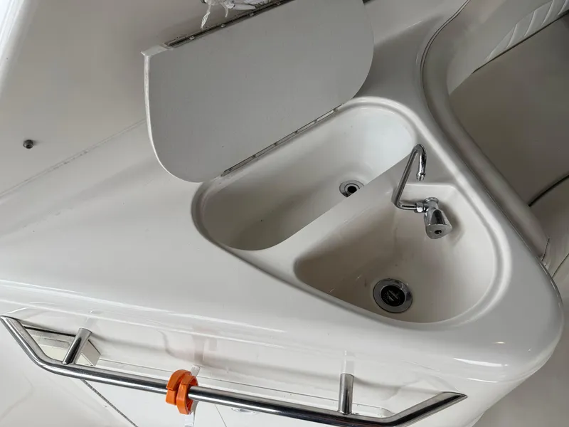Slide: The Image of 2003 Monterey 302 Cruiser boat sink with faucet and storage compartment. - 14