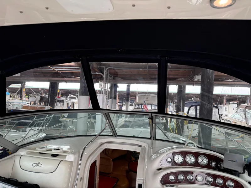 Slide: The Image of Interior view of 2003 Monterey 302 Cruiser at a marina, showcasing dashboard and controls. - 15