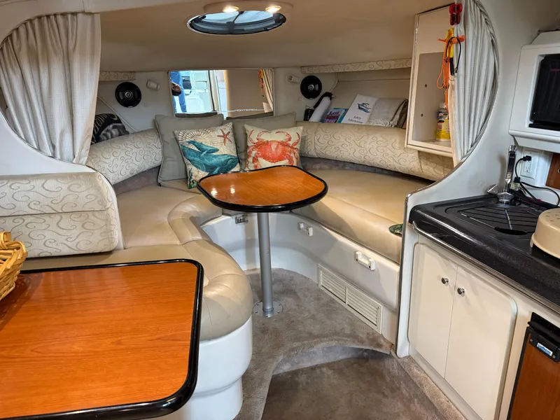 Slide: The Image of Interior of a 2003 Monterey 302 Cruiser with cozy seating and nautical decor. - 20