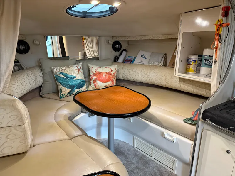 Slide: The Image of Interior of 2003 Monterey 302 Cruiser with cozy seating and nautical decor. - 21