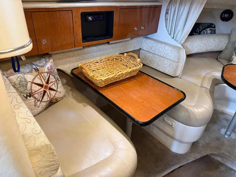 Slide: The Image of 2003 Monterey 302 Cruiser interior with seating, table, and decorative elements. - 22