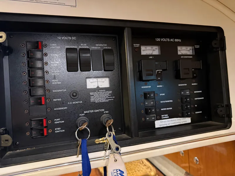 Slide: The Image of Electrical control panel of a 2003 Monterey 302 Cruiser boat with keys attached. - 24