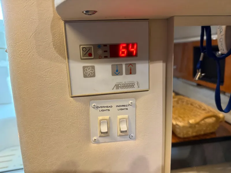 Slide: The Image of Control panel in a 2003 Monterey 302 Cruiser displaying temperature and light switches. - 25