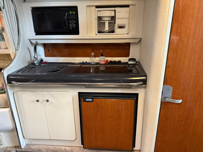 Slide: The Image of 2003 Monterey 302 Cruiser kitchen with microwave, coffee maker, sink, and mini fridge. - 27