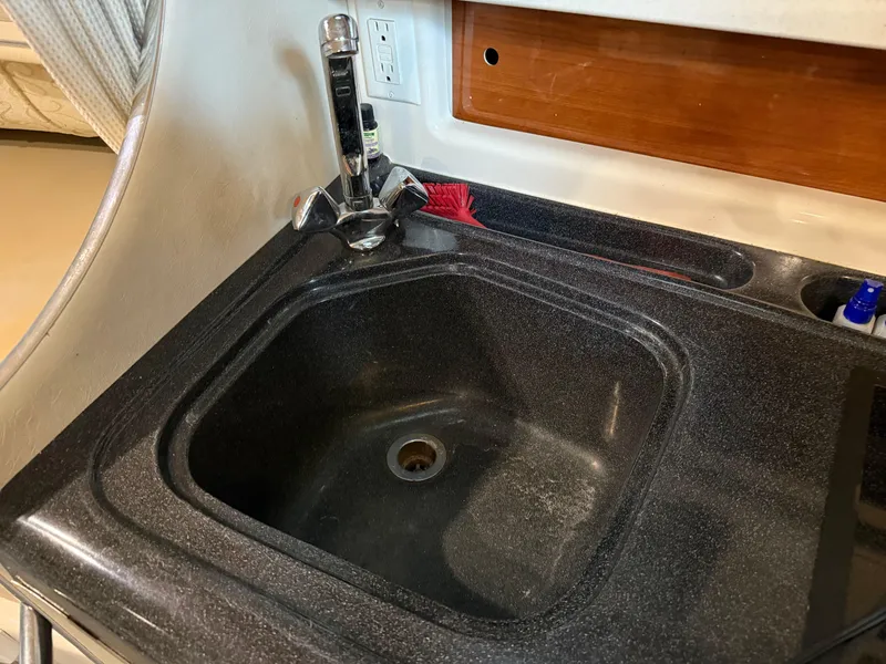 Slide: The Image of Kitchen sink in 2003 Monterey 302 Cruiser boat interior. - 32