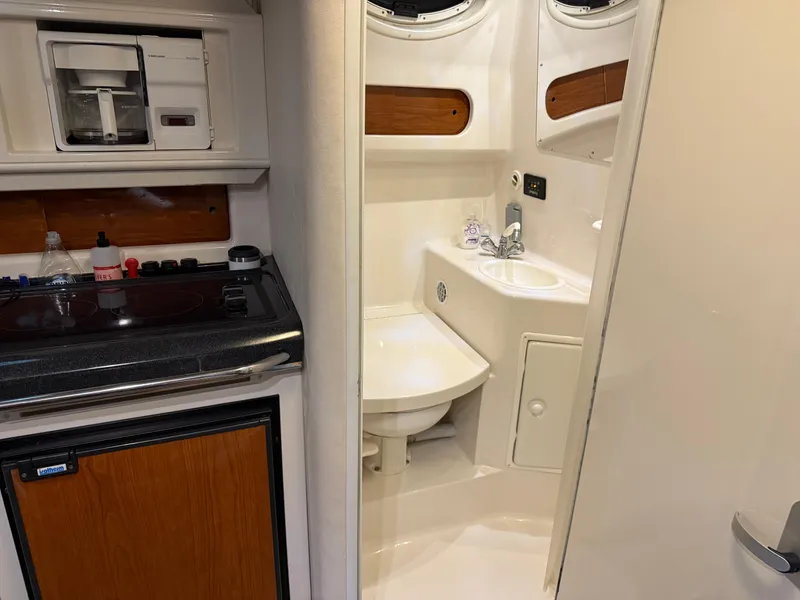 Slide: The Image of 2003 Monterey 302 Cruiser interior with compact kitchen and bathroom. - 33