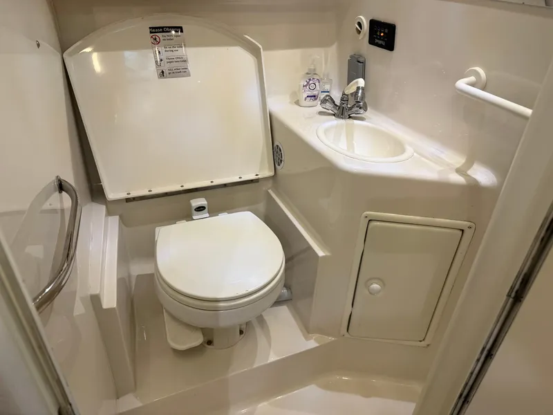 Slide: The Image of 2003 Monterey 302 Cruiser bathroom with toilet, sink, and storage cabinet. - 35