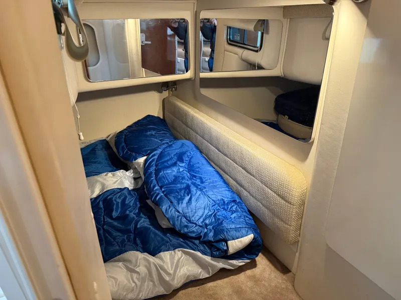 Slide: The Image of 2003 Monterey 302 Cruiser cabin with blue sleeping bags, cozy interior. - 38