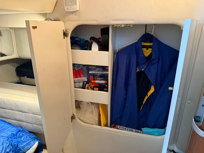 Slide: The Image of Interior storage of 2003 Monterey 302 Cruiser with hanging clothes and shelves. - 39