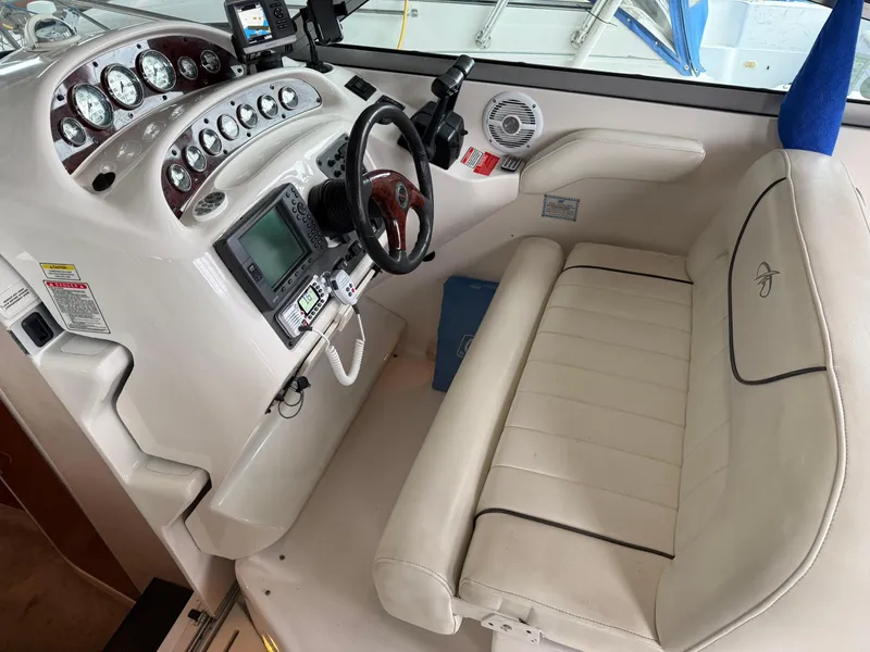 Slide: The Image of 2003 Monterey 302 Cruiser helm with steering wheel, gauges, and white seating. - 4
