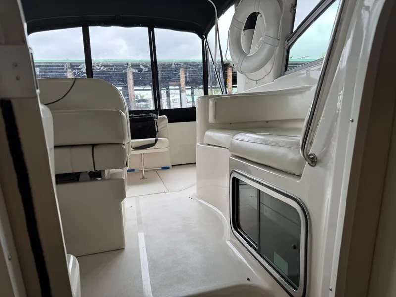 Slide: The Image of 2003 Monterey 302 Cruiser interior with white seating and life preserver. - 40