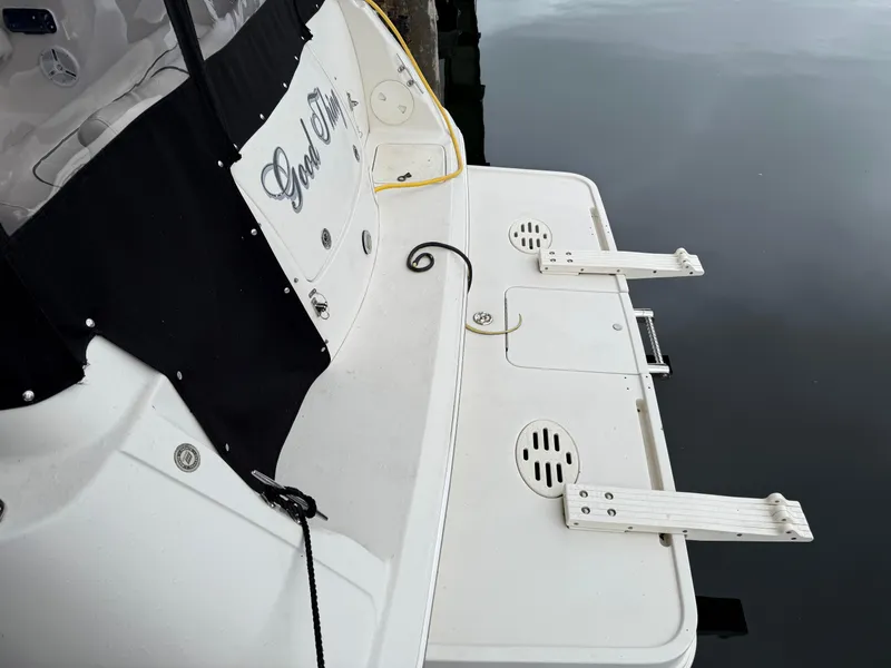 Slide: The Image of 2003 Monterey 302 Cruiser swim platform with ladder, docked on calm water. - 46