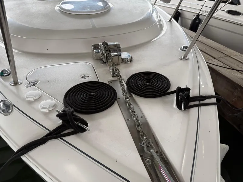 Slide: The Image of 2003 Monterey 302 Cruiser bow with anchor chain and coiled ropes. - 47