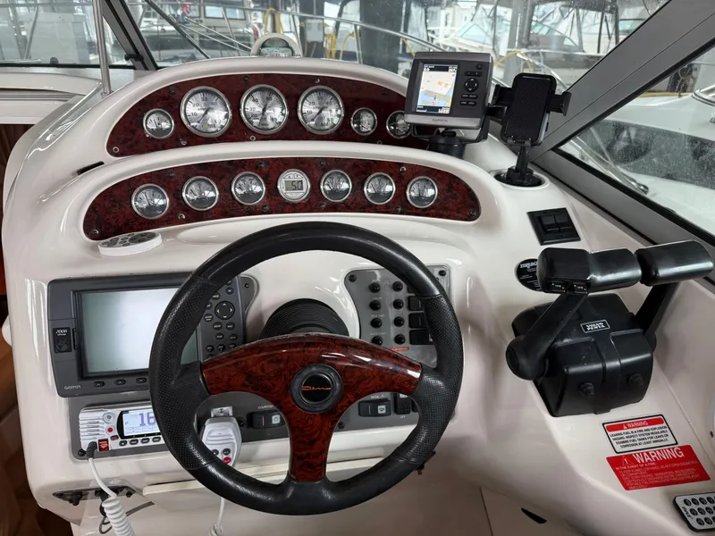 Slide: The Image of 2003 Monterey 302 Cruiser dashboard with steering wheel, gauges, and navigation equipment. - 6