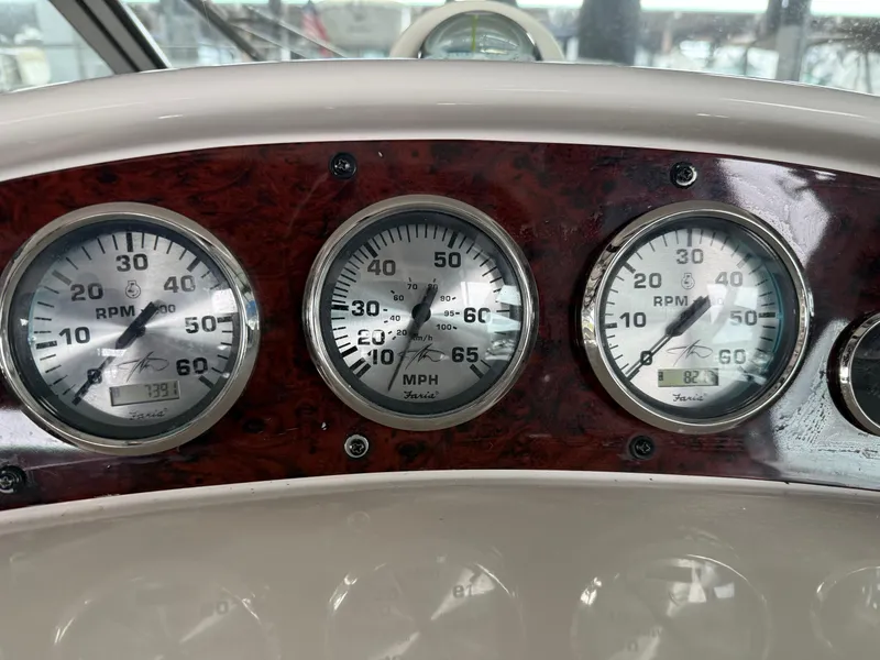 Slide: The Image of Dashboard gauges of a 2003 Monterey 302 Cruiser boat, displaying RPM and speed. - 9