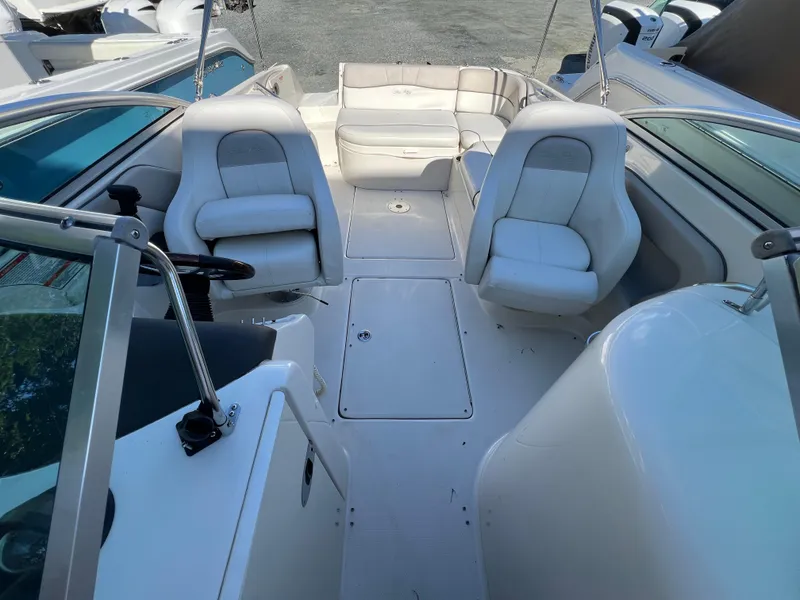 Slide: The Image of 2009 Sea Ray 240 Sundeck interior with white seating and spacious layout. - 4