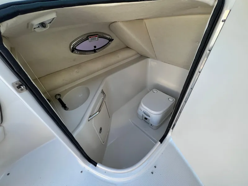 Slide: The Image of 2009 Sea Ray 240 Sundeck boat interior with compact bathroom and toilet. - 6
