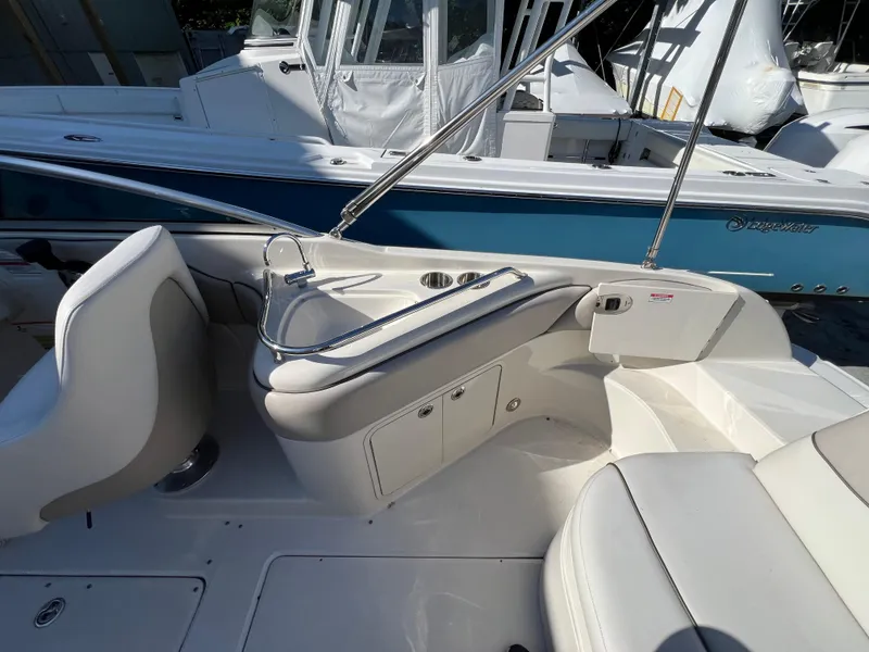Slide: The Image of 2009 Sea Ray 240 Sundeck interior with seating and storage compartments. - 7