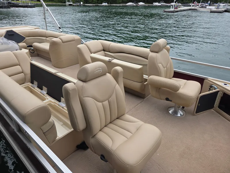 Slide: The Image of 2009 Bennington 2577RFSi pontoon boat with beige seating on a calm lake. - 1