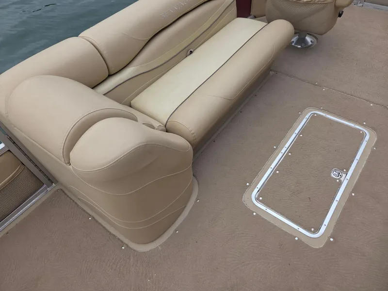 Slide: The Image of 2009 Bennington 2577RFSi boat interior with beige seating and storage hatch. - 6