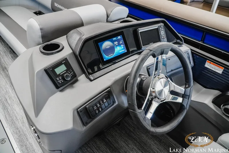 Slide: The Image of 2025 Bennington 23SSR boat dashboard with modern controls and steering wheel at Lake Norman Marina. - 10