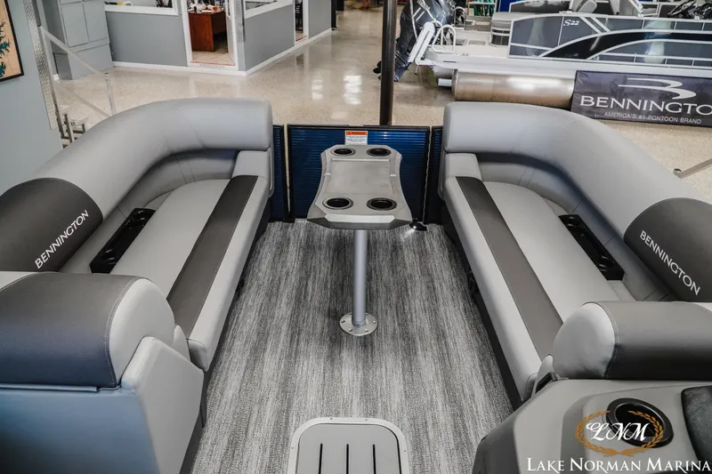 Slide: The Image of Interior of 2025 Bennington 23SSR pontoon boat with gray seating and table, at Lake Norman Marina. - 11