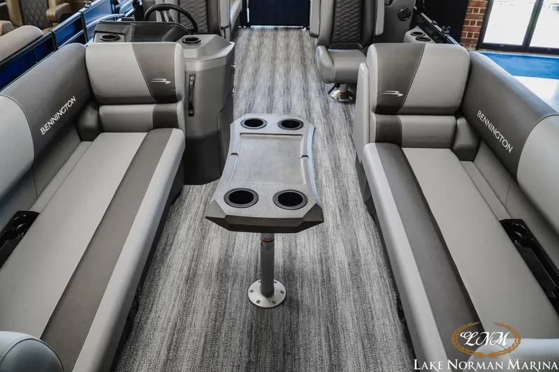 Slide: The Image of 2025 Bennington 23SSR pontoon boat interior with gray seating and central table. - 13