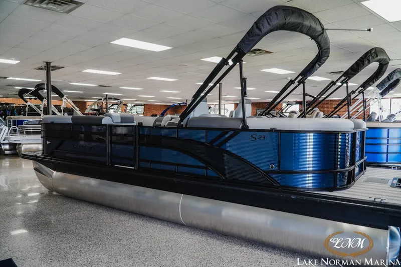 Slide: The Image of 2025 Bennington 23SSR pontoon boat displayed indoors at Lake Norman Marina. - 4