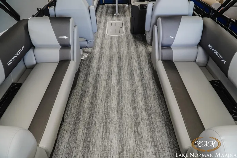Slide: The Image of 2025 Bennington 23SSR pontoon boat interior with gray seating and carpet flooring. - 6