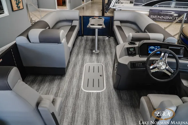 Slide: The Image of 2025 Bennington 23SSR pontoon boat interior with modern seating and steering console. - 7