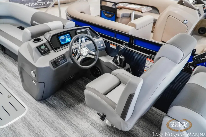 Slide: The Image of 2025 Bennington 23SSR boat interior with modern dashboard and comfortable seating at Lake Norman Marina. - 8