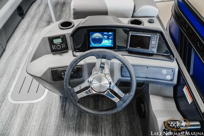 Slide: The Image of 2025 Bennington 23SSR boat dashboard with steering wheel and digital displays at Lake Norman Marina. - 9
