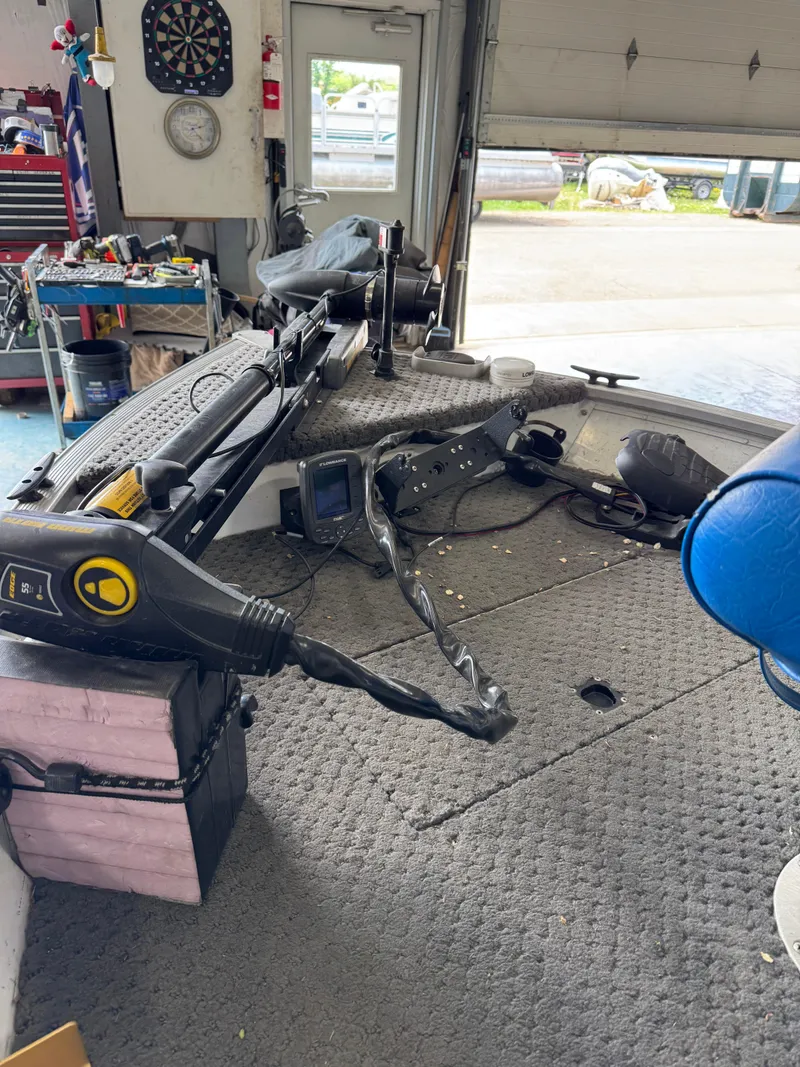 Slide: The Image of Interior of a 1994 Grumman 1676B boat with fishing equipment and tools. - 10