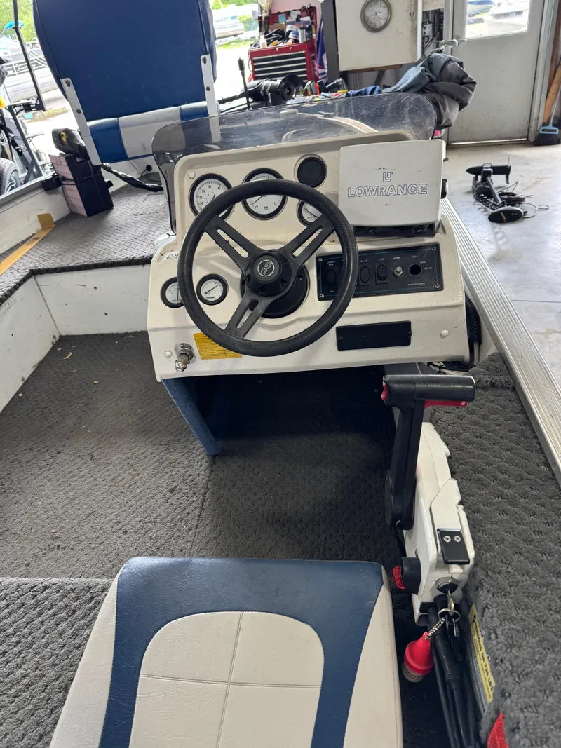 Slide: The Image of 1994 Grumman 1676B boat cockpit with steering wheel and control panel. - 5
