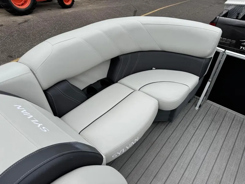 Slide: The Image of 2024 Sylvan Mirage 822 LZ boat interior with gray seating and cup holders. - 10