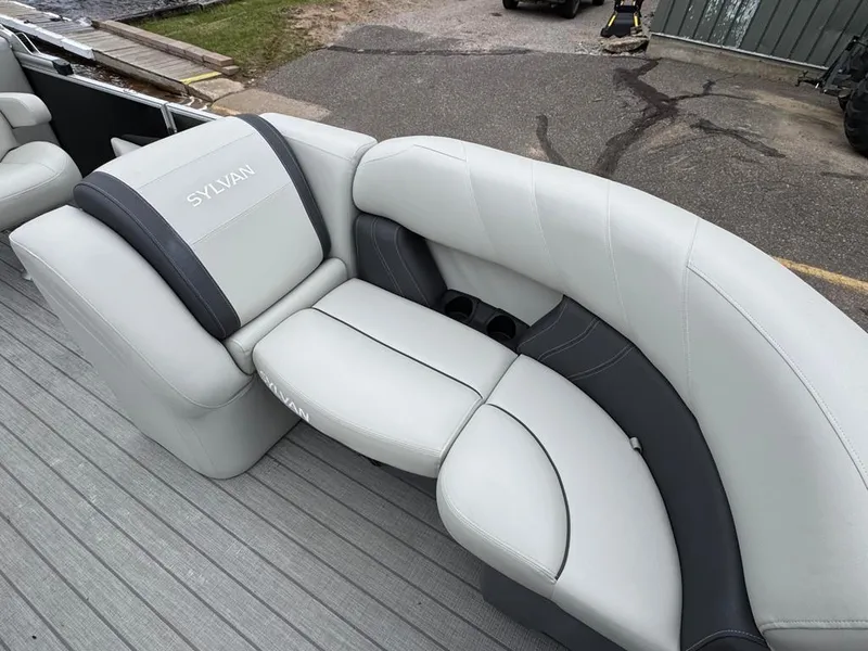 Slide: The Image of 2024 Sylvan Mirage 822 LZ boat interior with gray and black seating. - 12