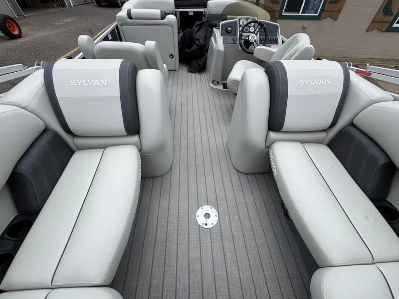 Slide: The Image of 2024 Sylvan Mirage 822 LZ pontoon boat interior with luxurious seating and modern dashboard. - 18