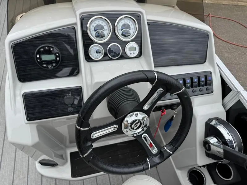 Slide: The Image of 2024 Sylvan Mirage 822 LZ dashboard with steering wheel and control panel. - 19