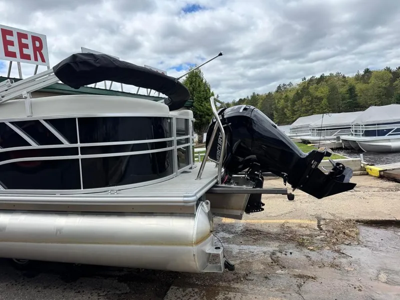 Slide: The Image of 2024 Sylvan Mirage 822 LZ pontoon boat with Mercury outboard motor, docked outdoors. - 5