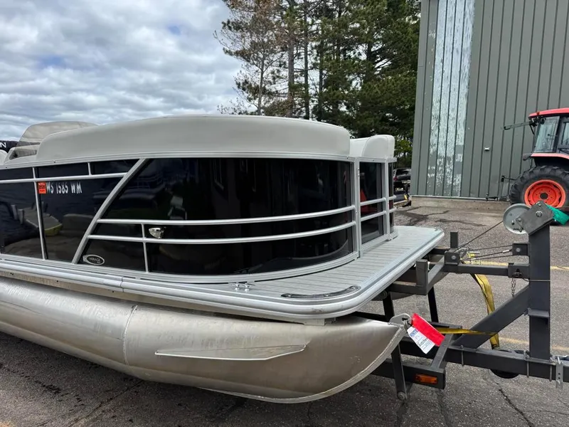 Slide: The Image of 2024 Sylvan Mirage 822 LZ pontoon boat on trailer, parked outdoors. - 6