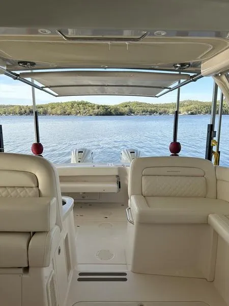 Slide: The Image of 2024 Grady-White Freedom 335 boat interior with lake view, featuring comfortable seating. - 10