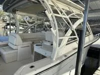 Slide: The Image of 2024 Grady-White Freedom 335 boat interior with seating and helm under a canopy. - 14